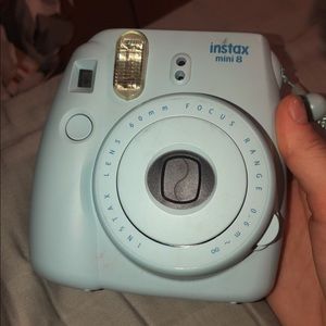 polaroid camera with thing of film